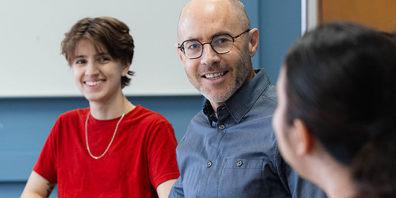 Faculty/Staff conversing with multiple students