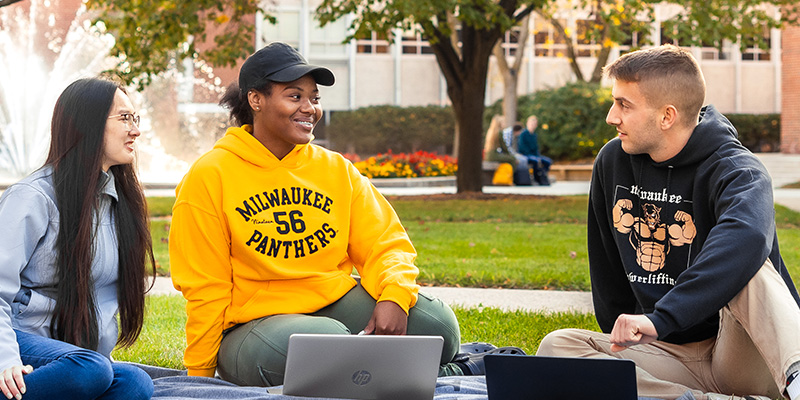 Students talking in front of the UWM Fountain